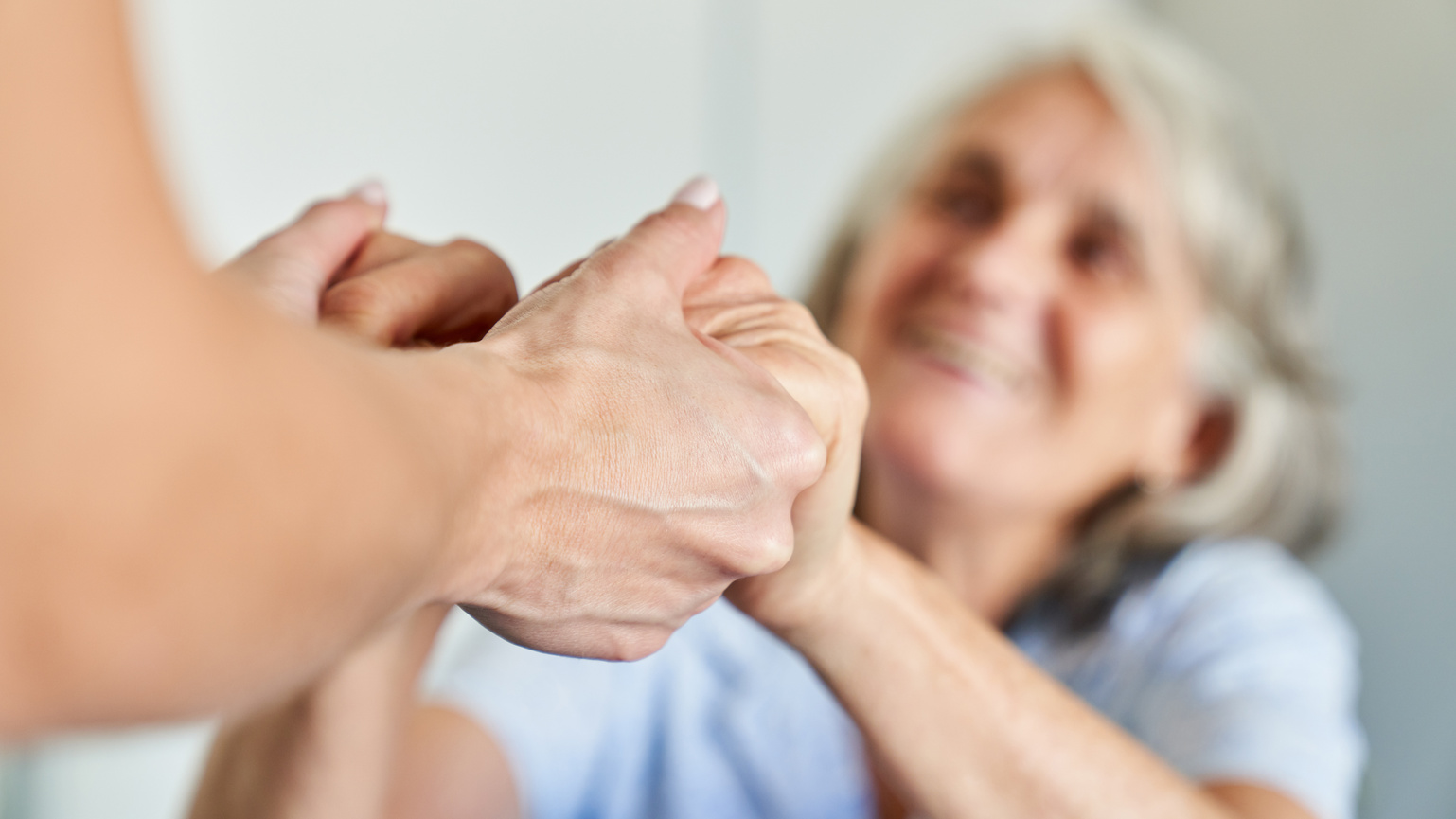 Hands of a Senior Citizen Hold for Support and Comfort